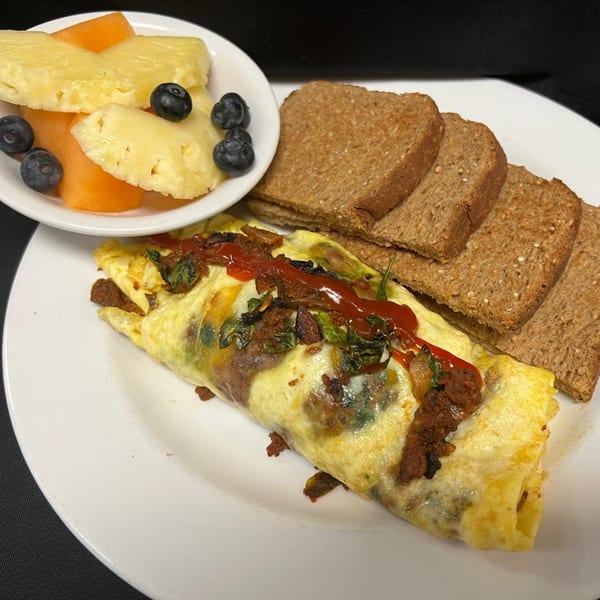 Pasifika NW Grill & Bar's omelet with salsa, spinach, and chorizo, served with toast and fruit.