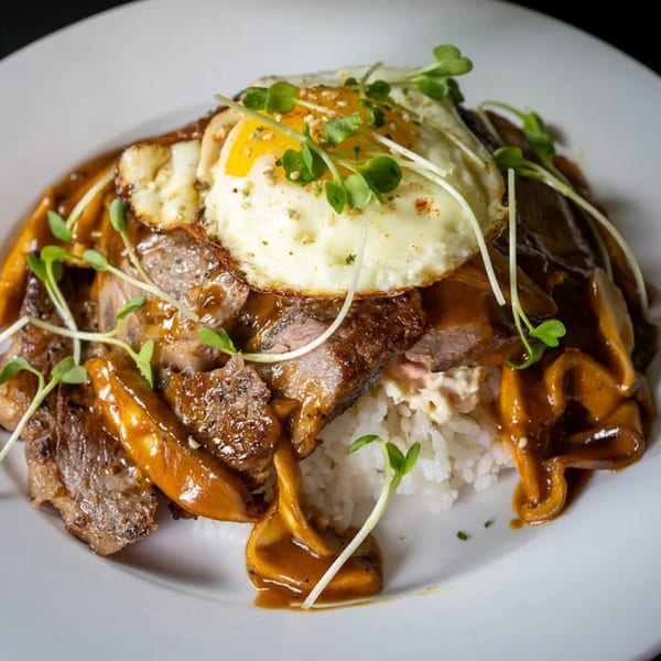 Pasifika NW Grill & Bar's Loco Moco with steak, gravy, mushrooms, rice, and a fried egg.